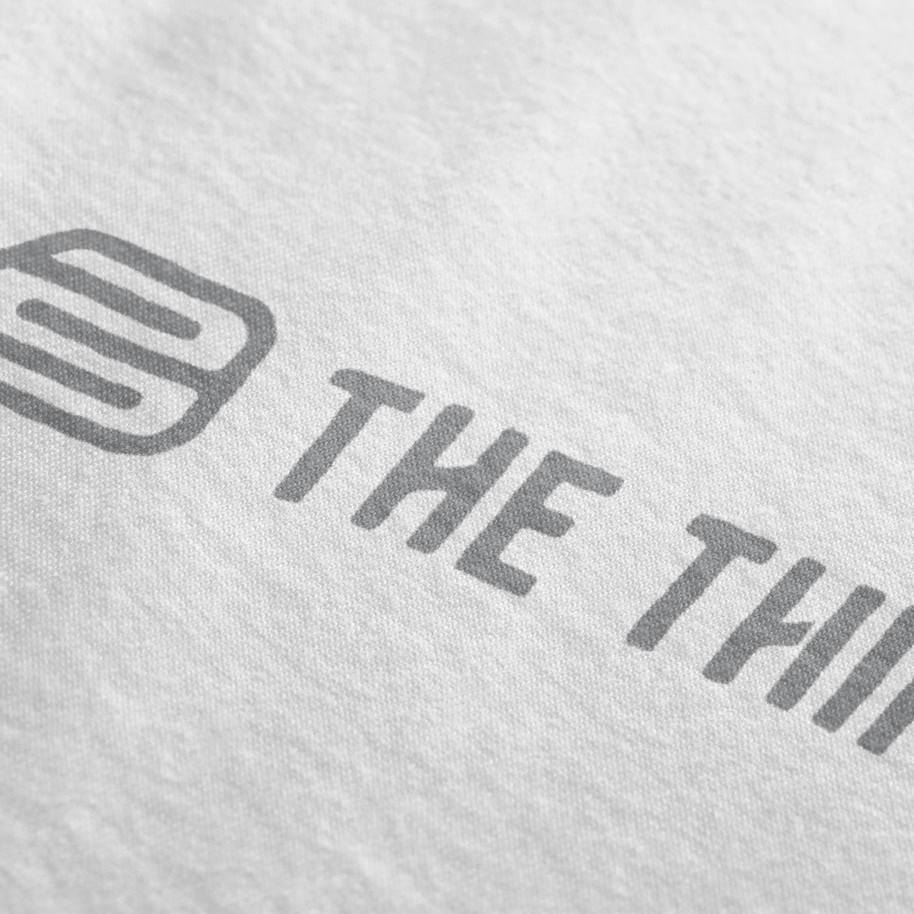 Close-up of The Third Shot pickleball sun sleeve showing single-color grey logo detail, breathable UV protection sleeve for pickleball players.