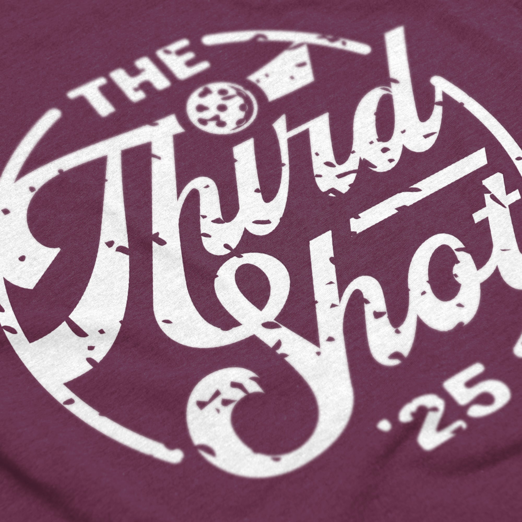 Close-up of Women’s Heritage pickleball shirt in lush – retro circular logo detail