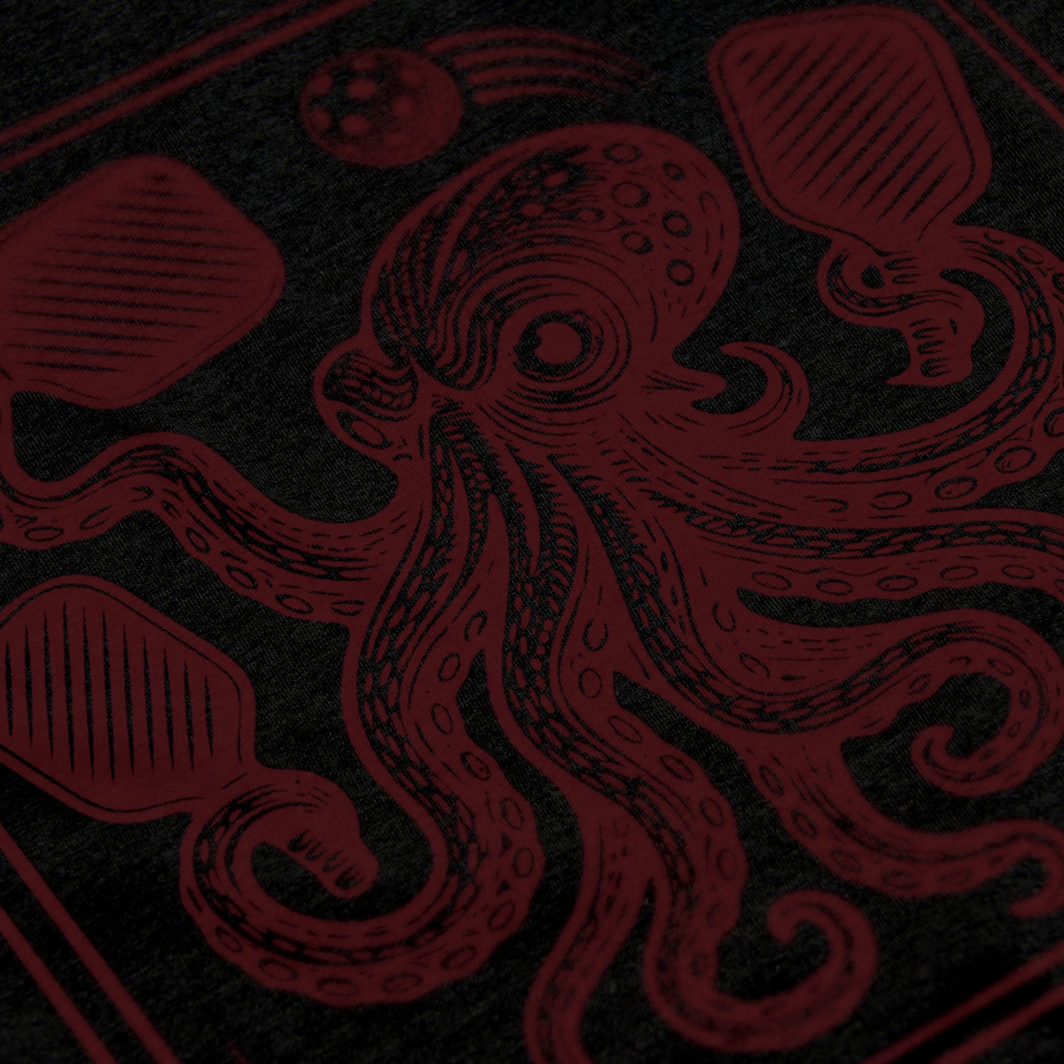 Close-up of Men’s Kraken pickleball shirt in black – tentacle graphic detail on chest