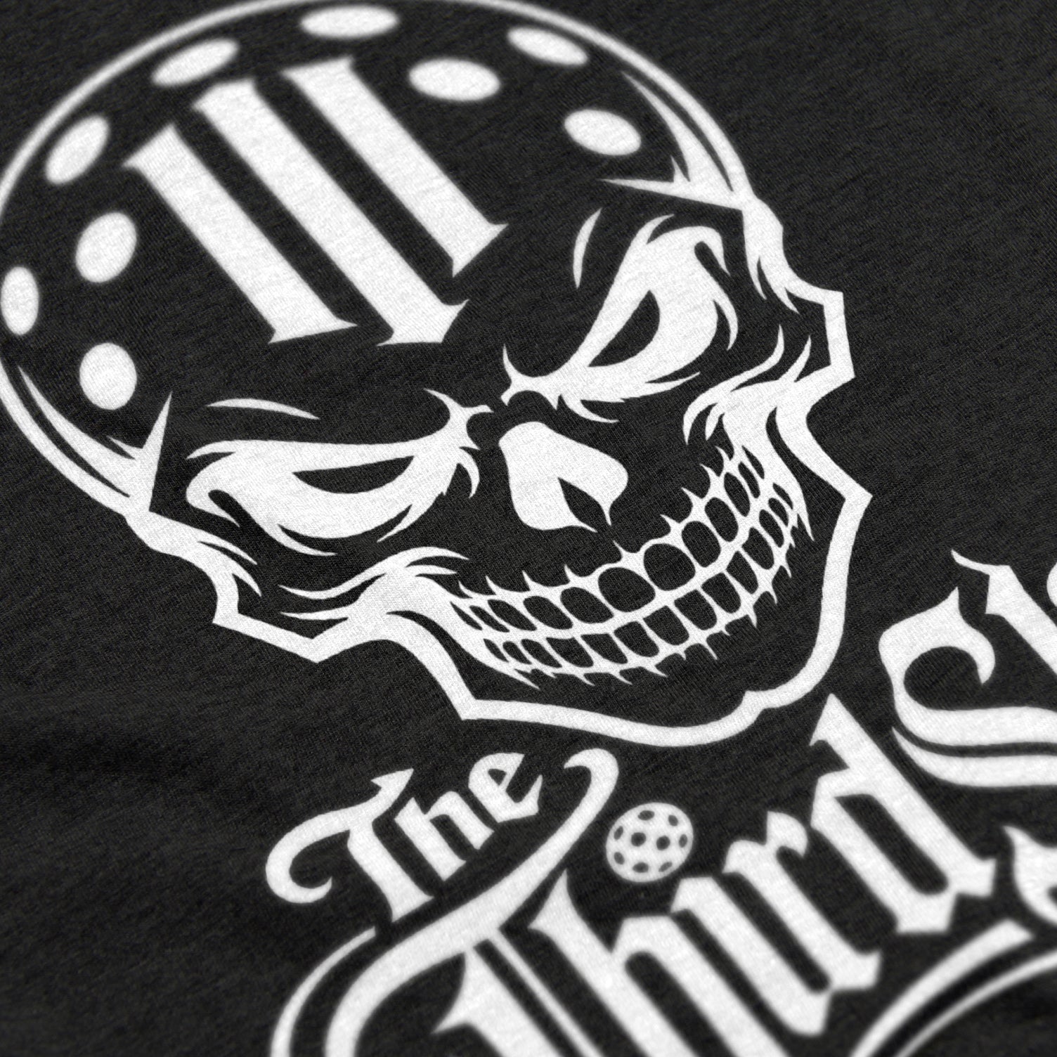 Close-up of Reaper pickleball shirt in black – skull graphic detail on front