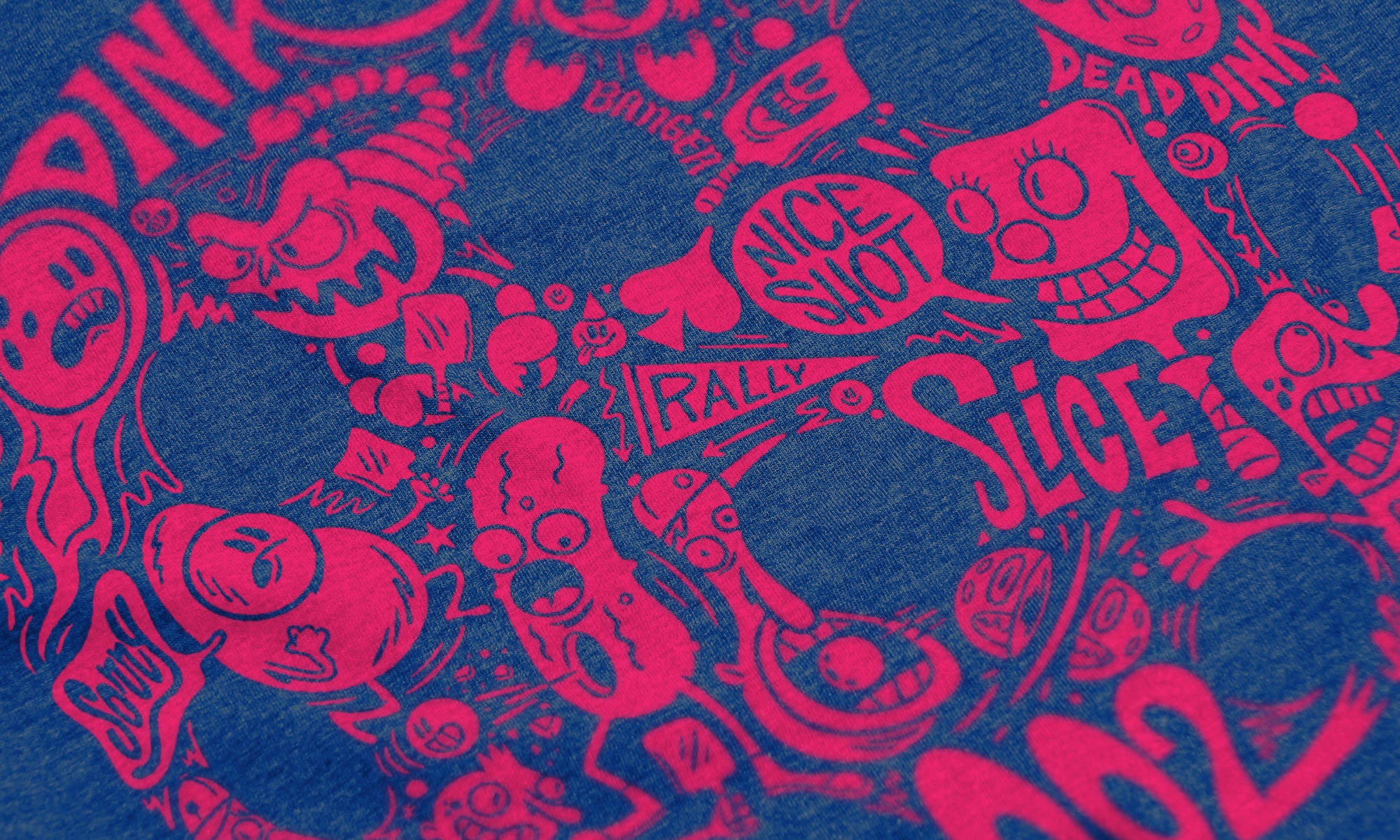 Close-up of Riot pickleball shirt in blue – graffiti slang artwork detail