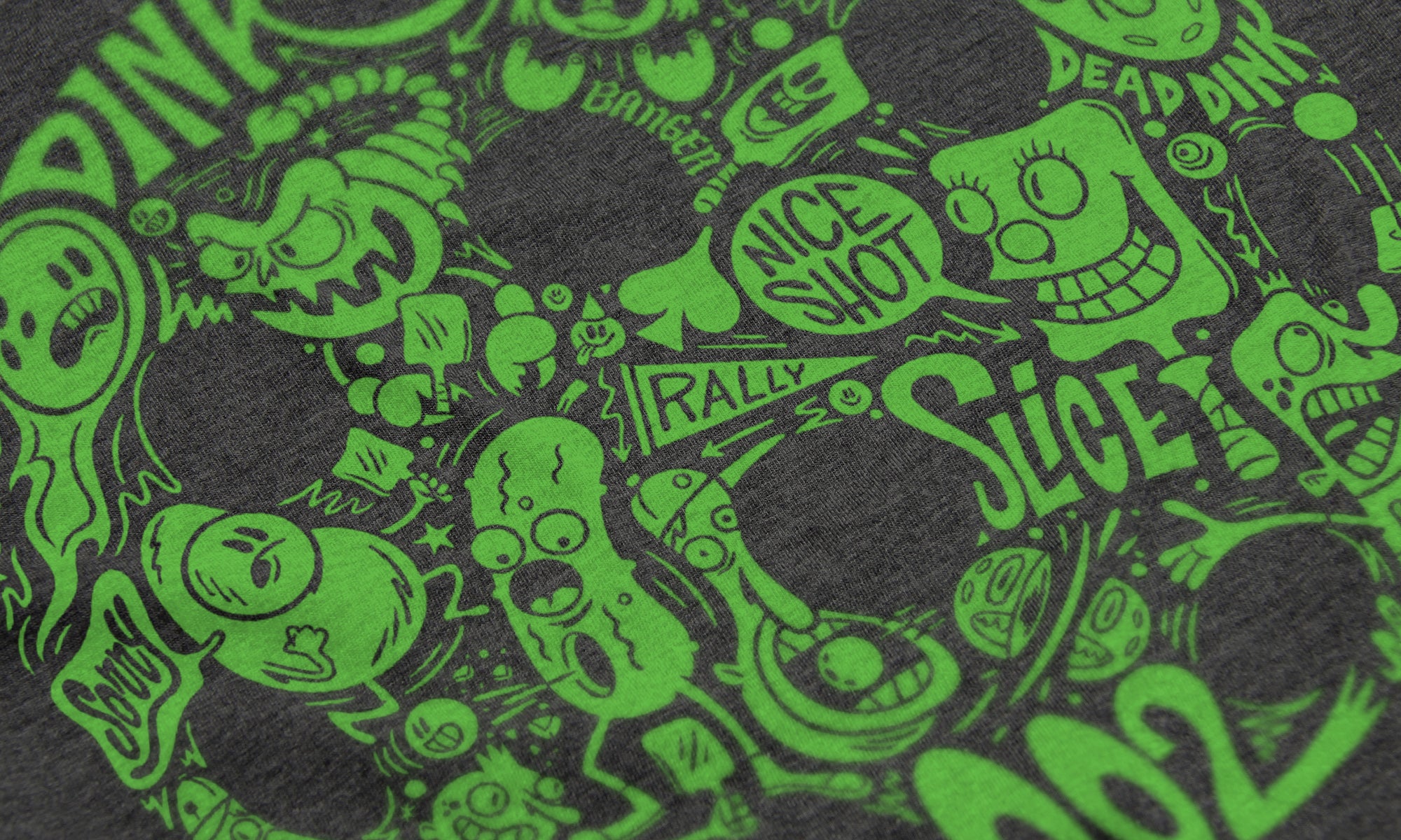 Close-up of Riot pickleball shirt in charcoal – graffiti slang artwork detail