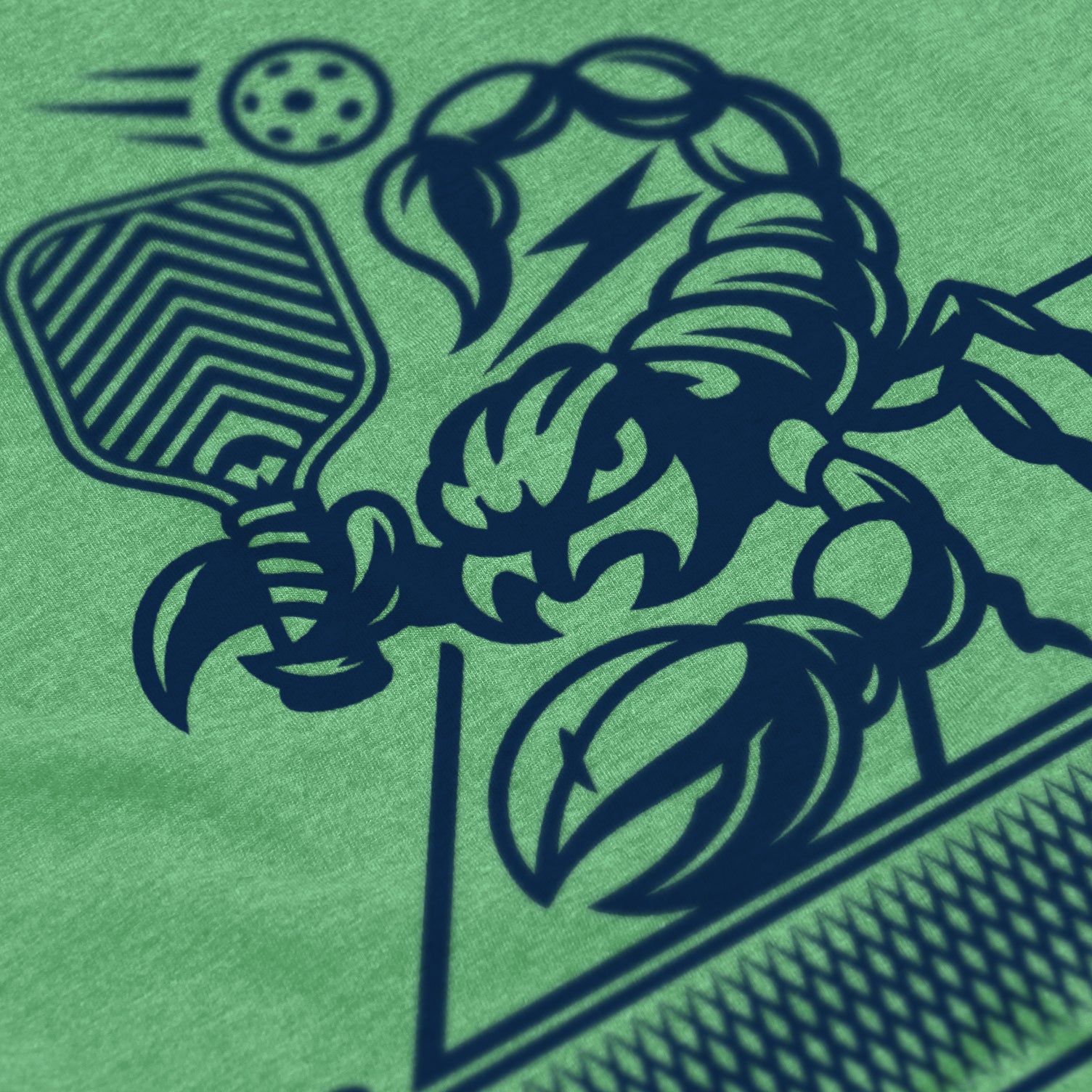 Close-up of Sting pickleball shirt in apple green – scorpion holding paddle graphic detail on back