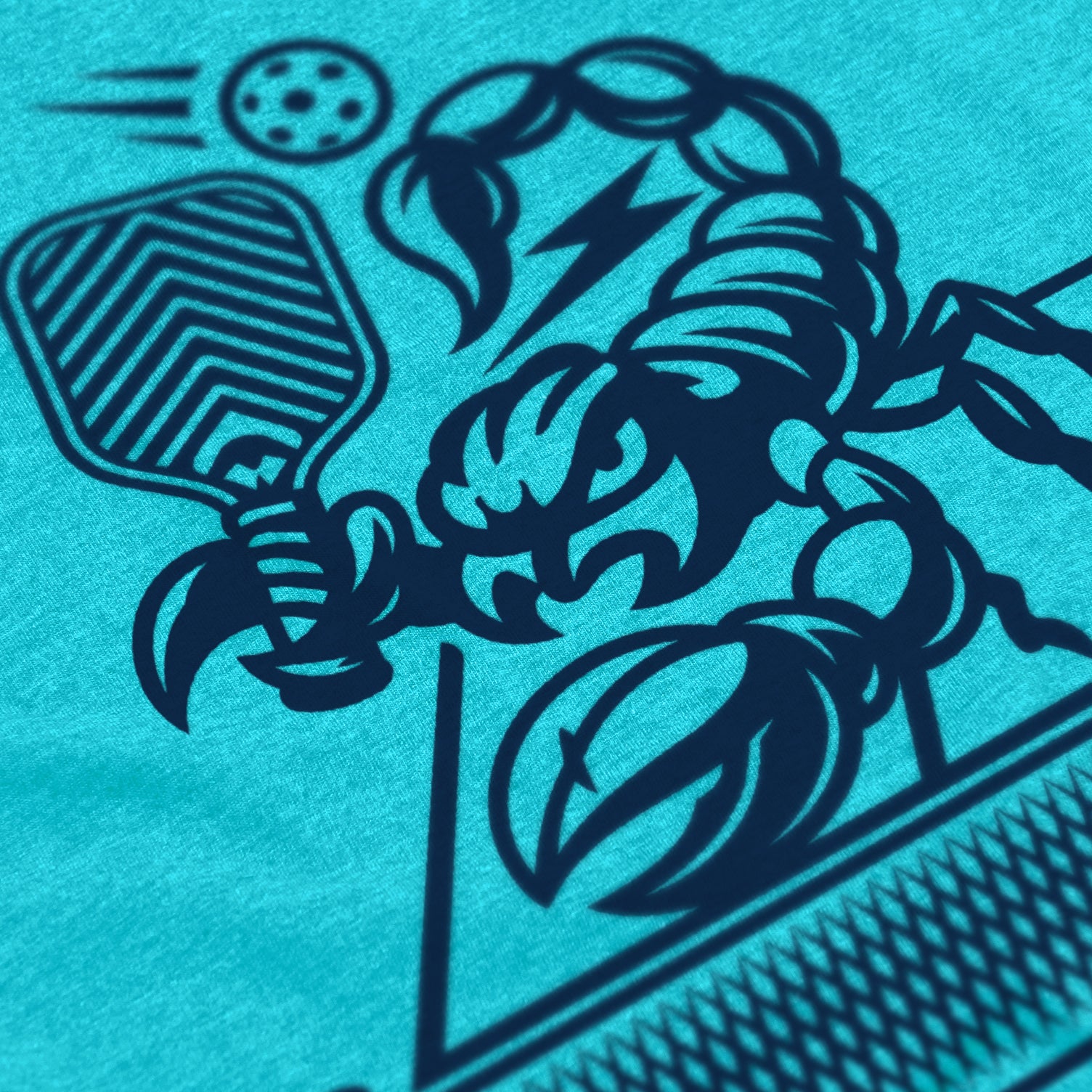 Close-up of Sting pickleball shirt in Bondi – scorpion holding paddle graphic detail on back