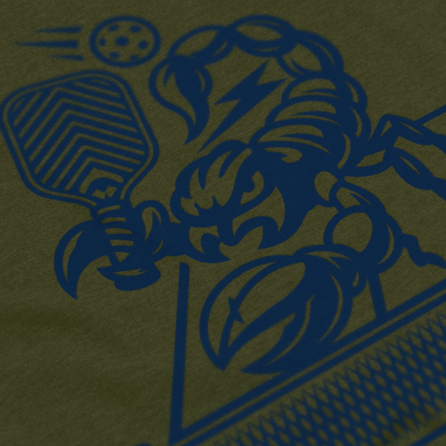 Close-up of Sting pickleball shirt in military – scorpion holding paddle graphic detail on back