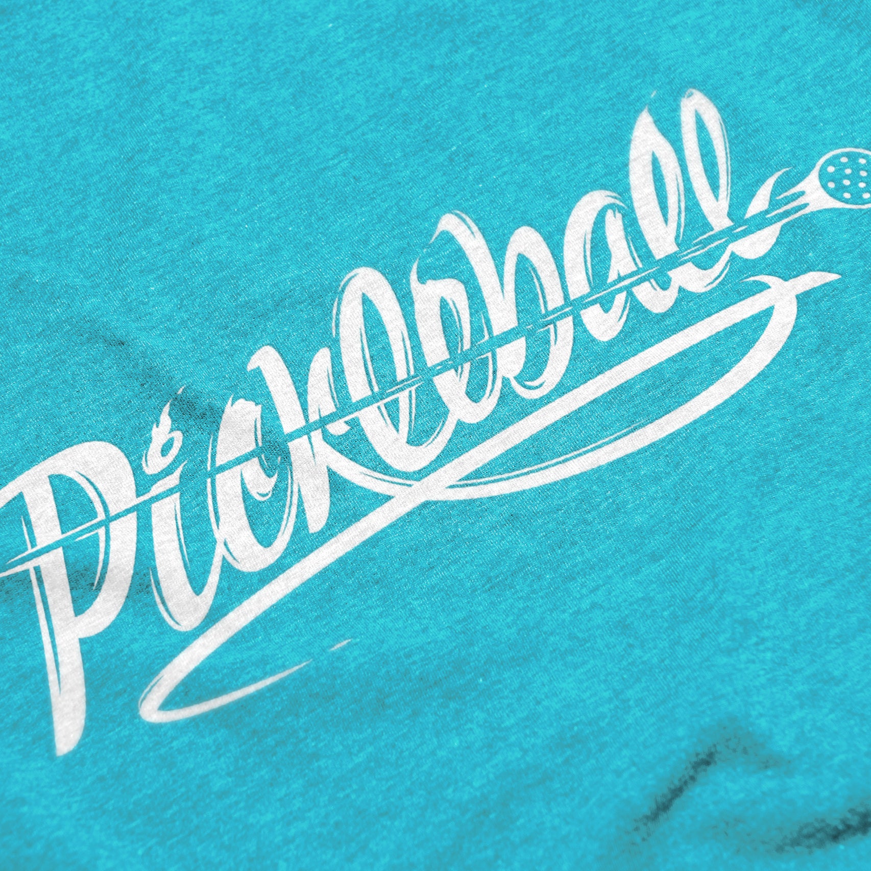 Close-up of Women’s Velocity pickleball shirt in blue – motion-inspired script logo detail