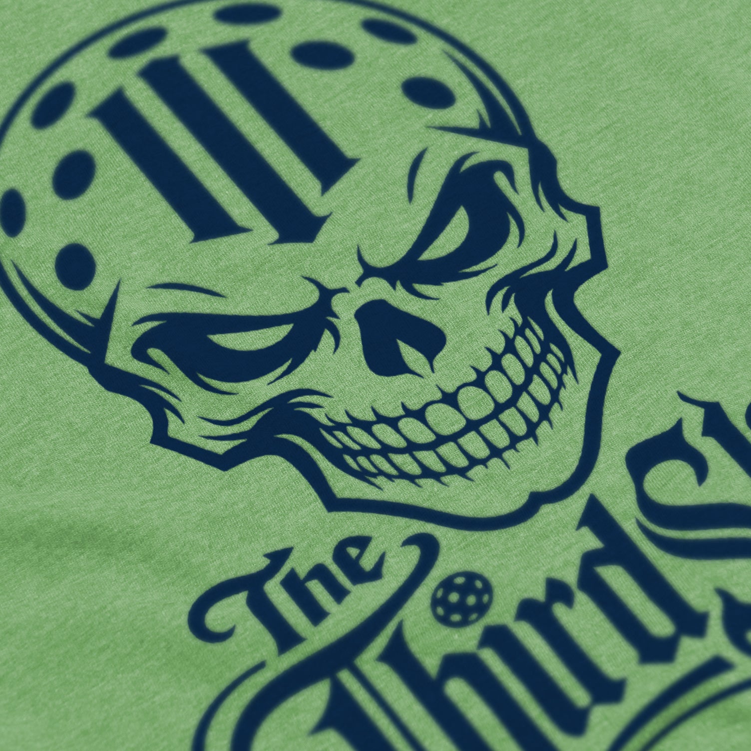 Close-up of Reaper pickleball shirt in apple green – skull graphic detail on front
