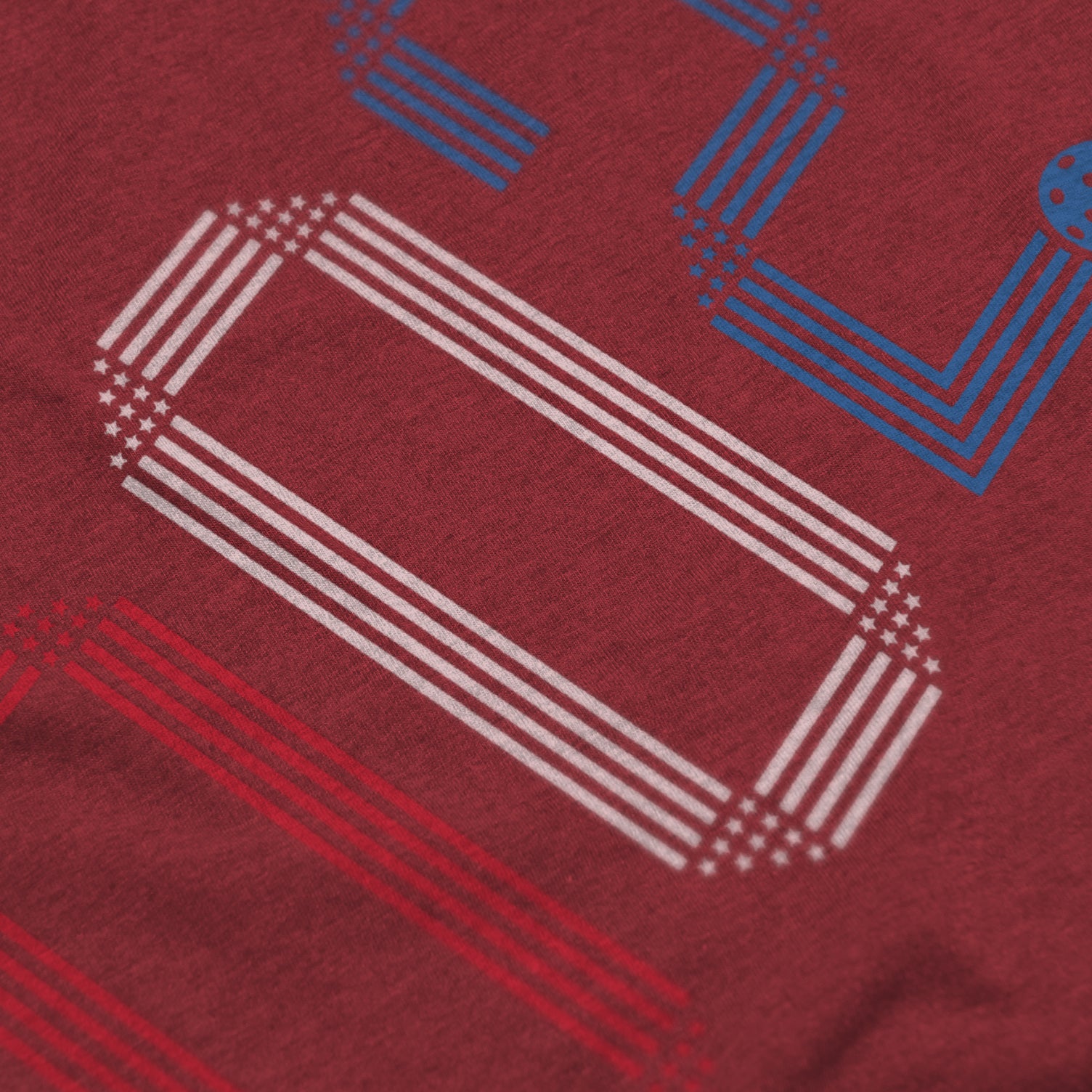 Close-up of Rise pickleball shirt in cardinal – patriotic stars stripes score 002 graphic detail on front