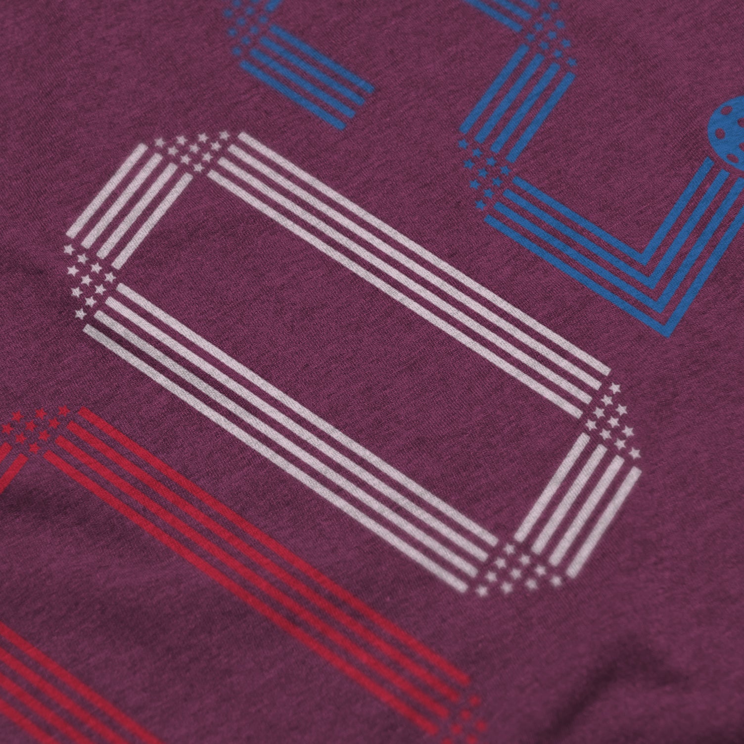 Close-up of Rise pickleball shirt in lush – patriotic stars stripes score 002 graphic detail on front