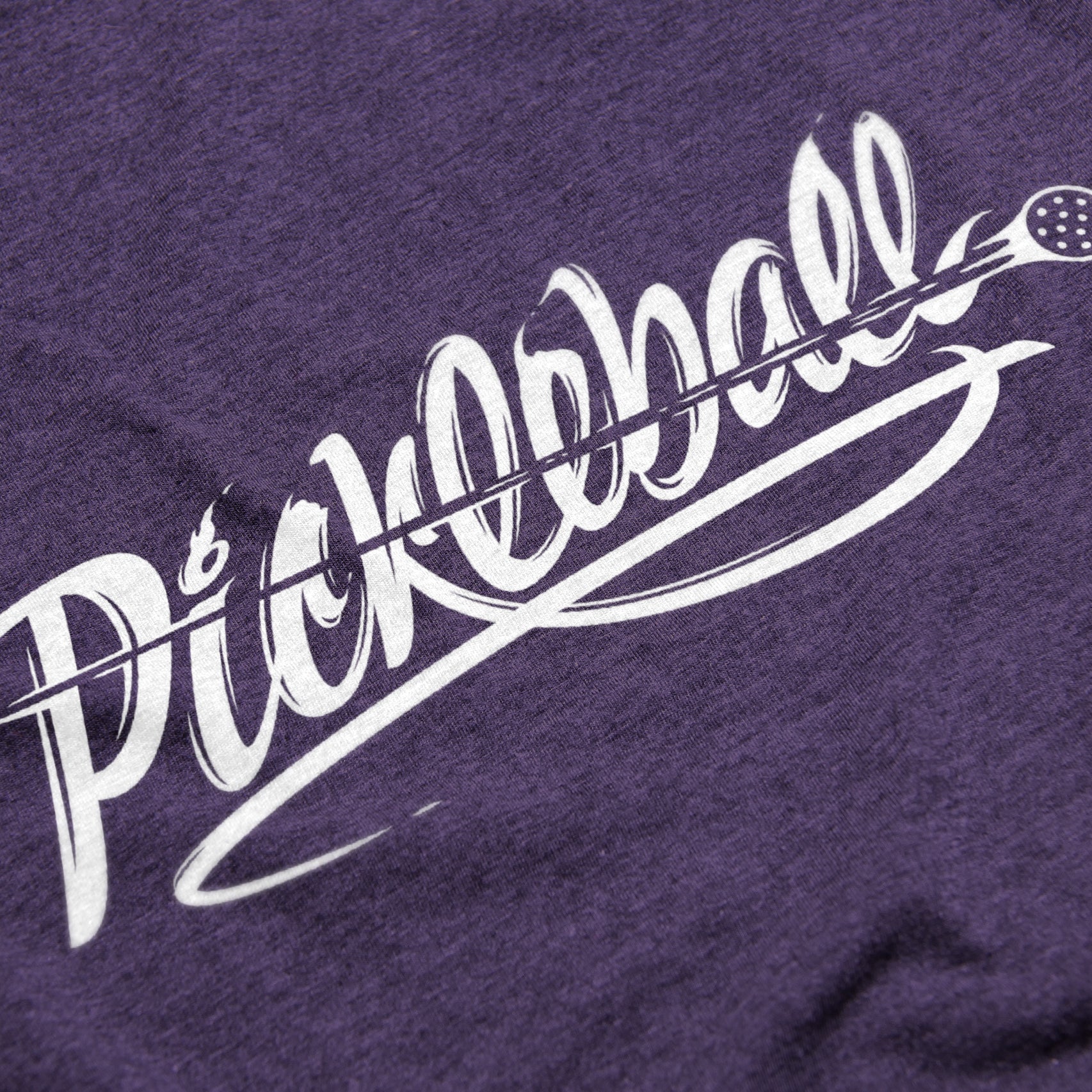 Close-up of Women’s Velocity pickleball shirt in purple – motion-inspired script logo detail